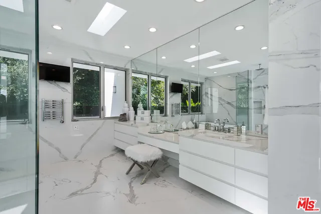 a large bathroom with a large mirror vanity and sink