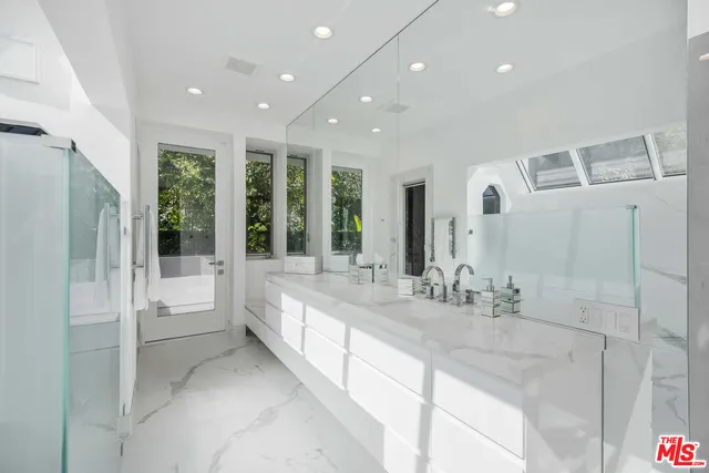 a large bathroom with a large tub and sink