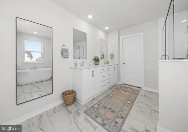 a en suite bathroom with a sink a mirror and shower