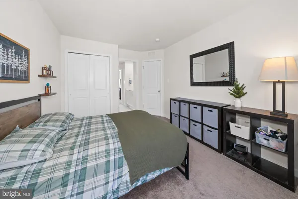a room with gym equipment and wooden floor