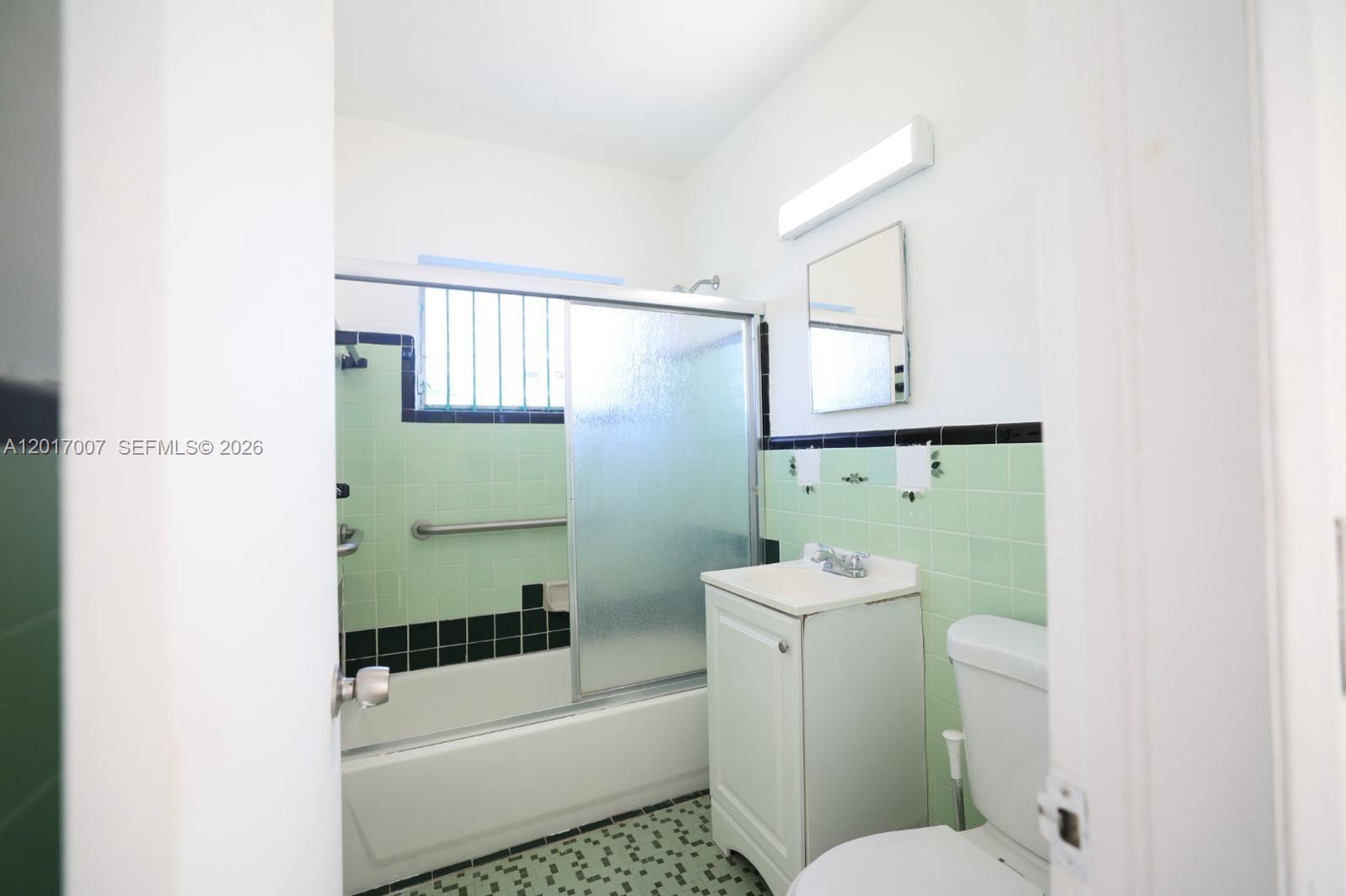 800 83rd Street, Unit 2 Miami Beach, FL 33141 - Photo 8 of 10 a bathroom with a sink a toilet and shower
