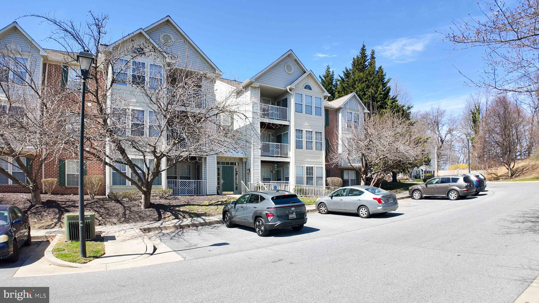 7903 Valley Manor Road, Unit 103 Owings Mills, MD 21117 - Photo 11 of 58 a view of a parked cars in front of a building