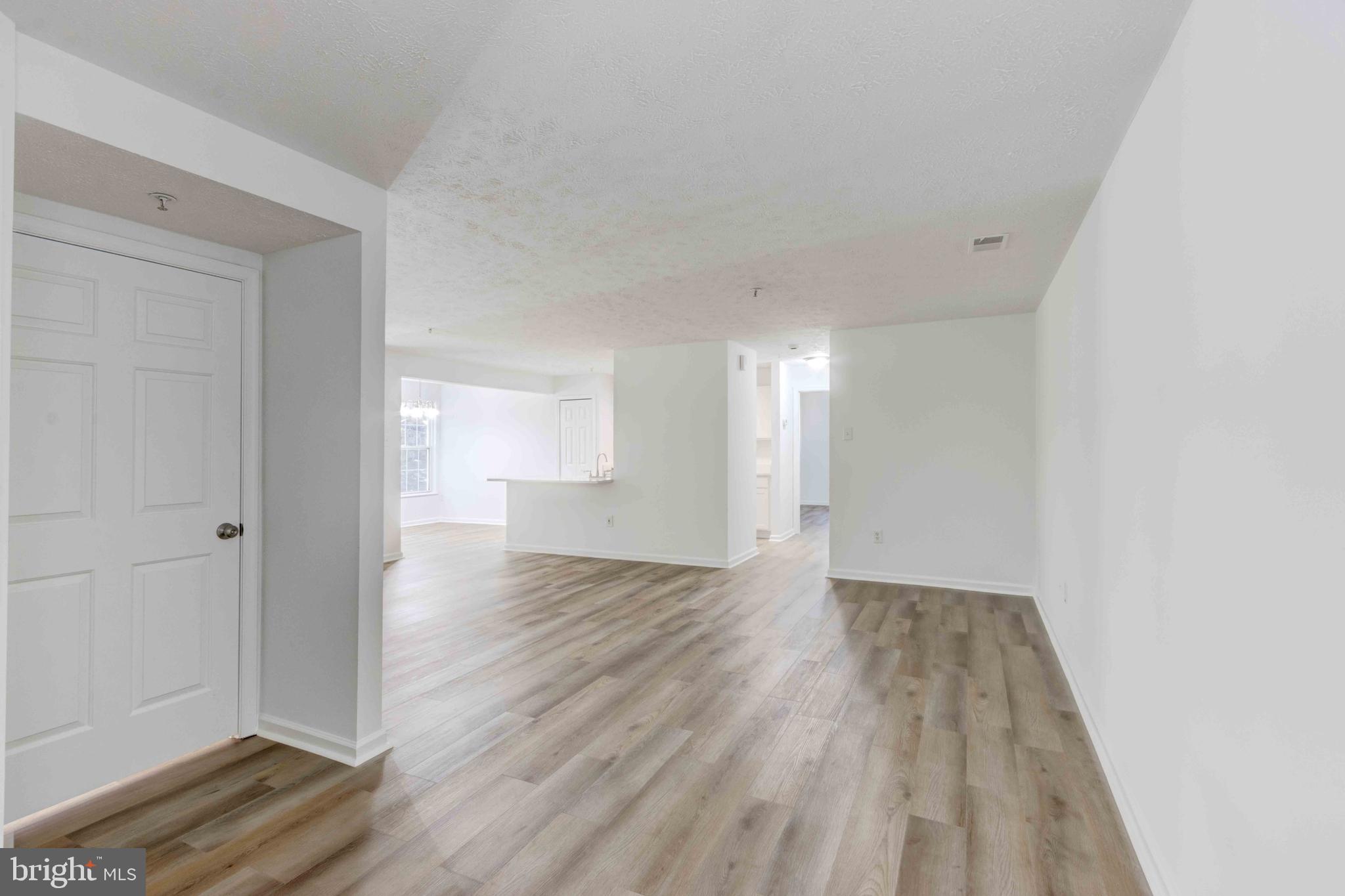 7903 Valley Manor Road, Unit 103 Owings Mills, MD 21117 - Photo 15 of 58 a view of an empty room and wooden floor