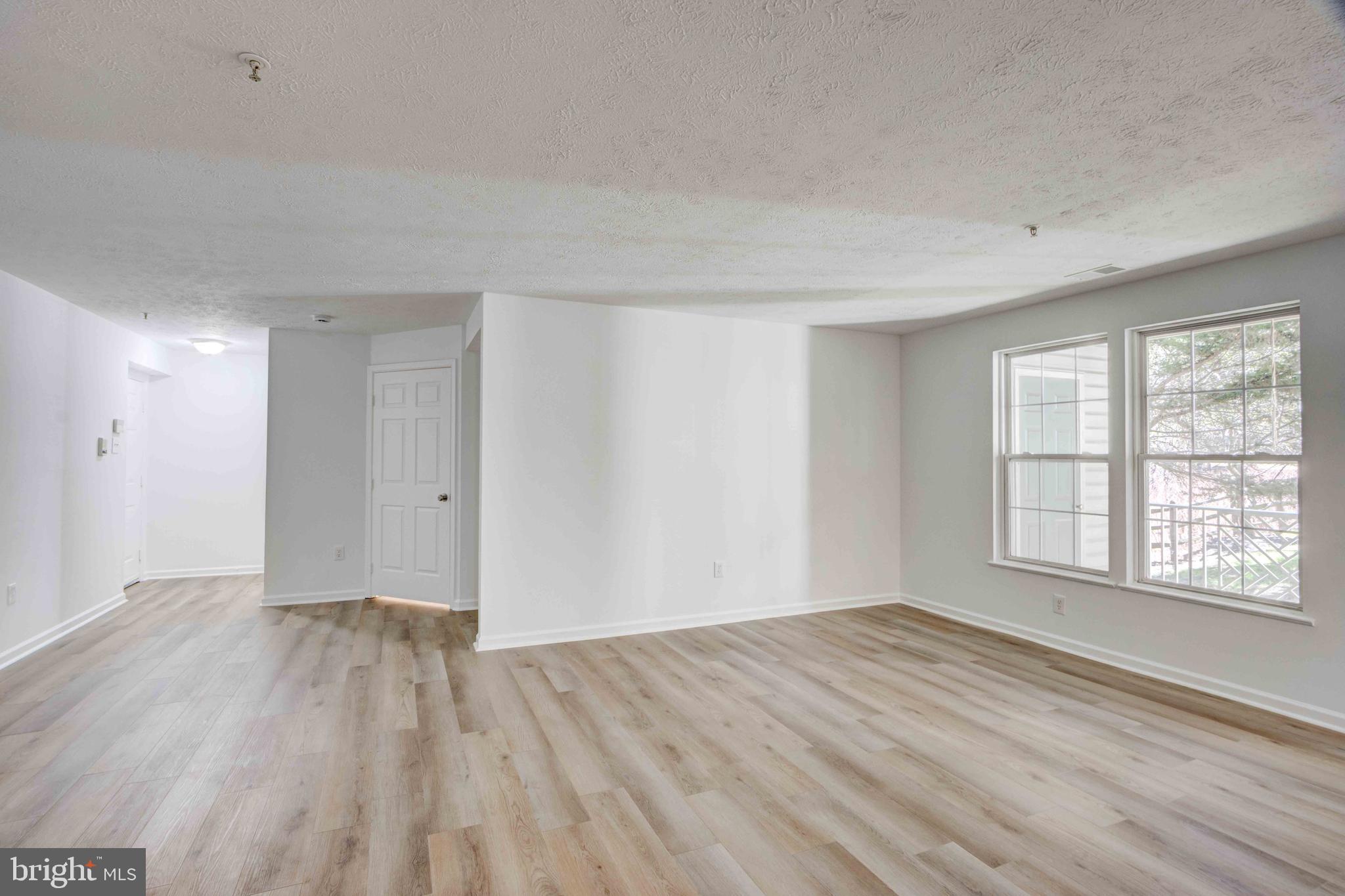7903 Valley Manor Road, Unit 103 Owings Mills, MD 21117 - Photo 17 of 58 a view of empty room with wooden floor and fan
