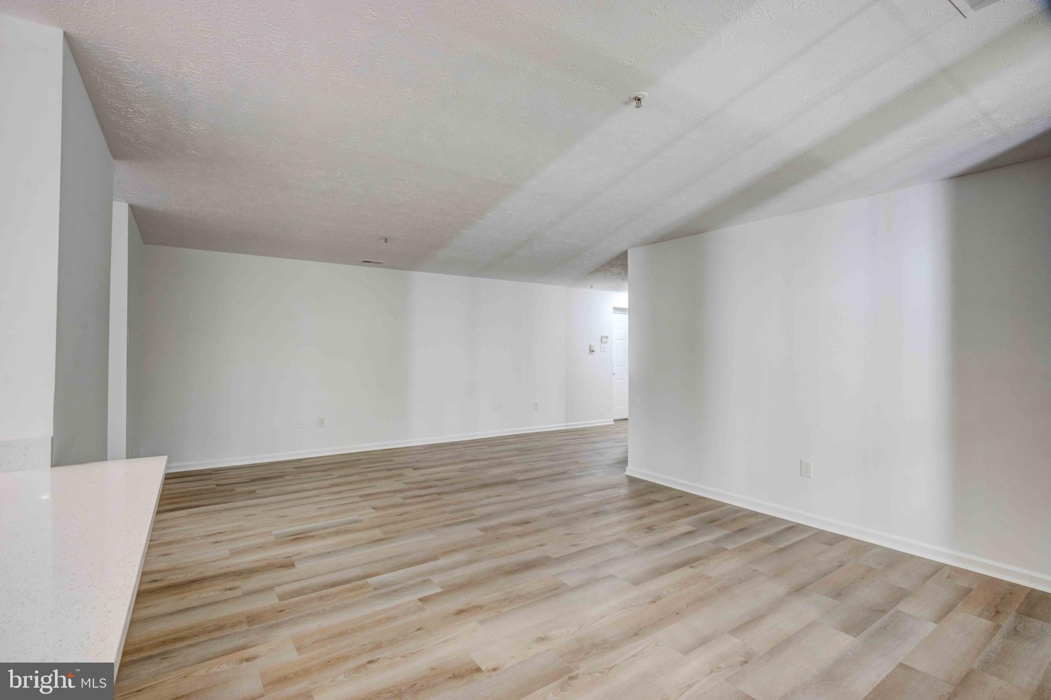 7903 Valley Manor Road, Unit 103 Owings Mills, MD 21117 - Photo 18 of 58 a view of an empty room with wooden floor