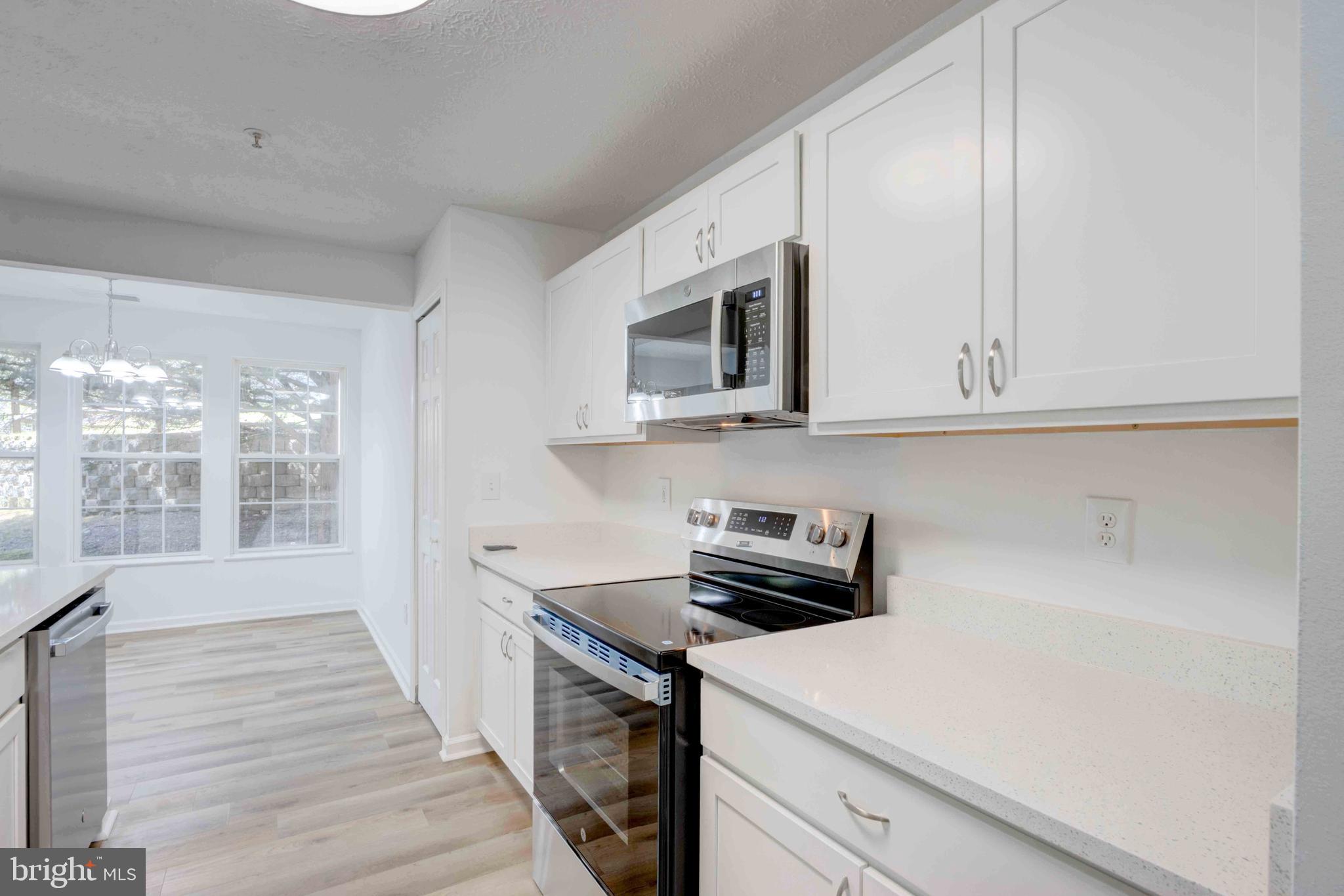 7903 Valley Manor Road, Unit 103 Owings Mills, MD 21117 - Photo 24 of 58 a kitchen with a sink and cabinets