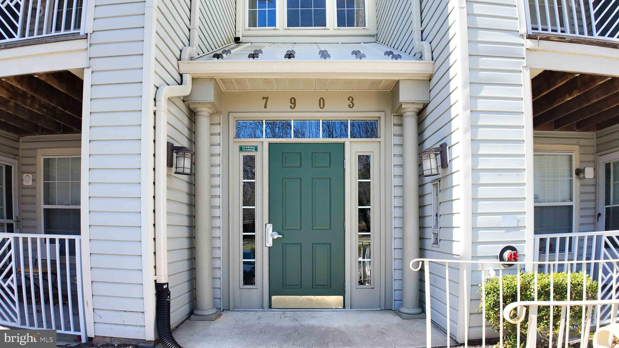 7903 Valley Manor Road, Unit 103 Owings Mills, MD 21117 - Photo 3 of 58 a front view of a house with plants