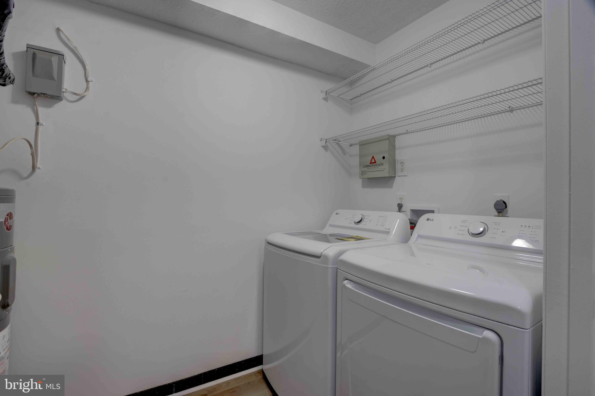 7903 Valley Manor Road, Unit 103 Owings Mills, MD 21117 - Photo 32 of 58 a utility room with dryer and washer