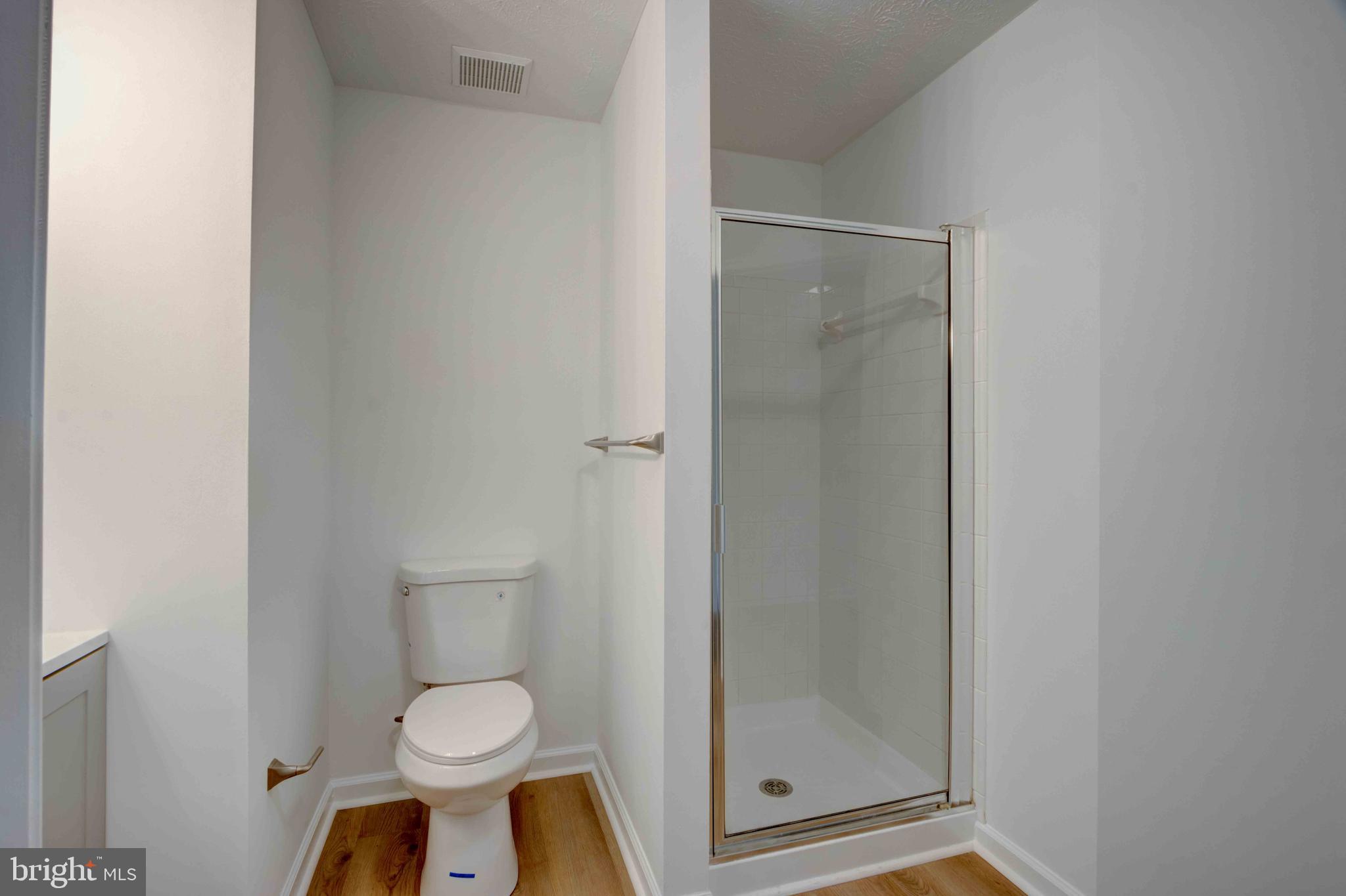 7903 Valley Manor Road, Unit 103 Owings Mills, MD 21117 - Photo 34 of 58 a bathroom with a toilet and a shower