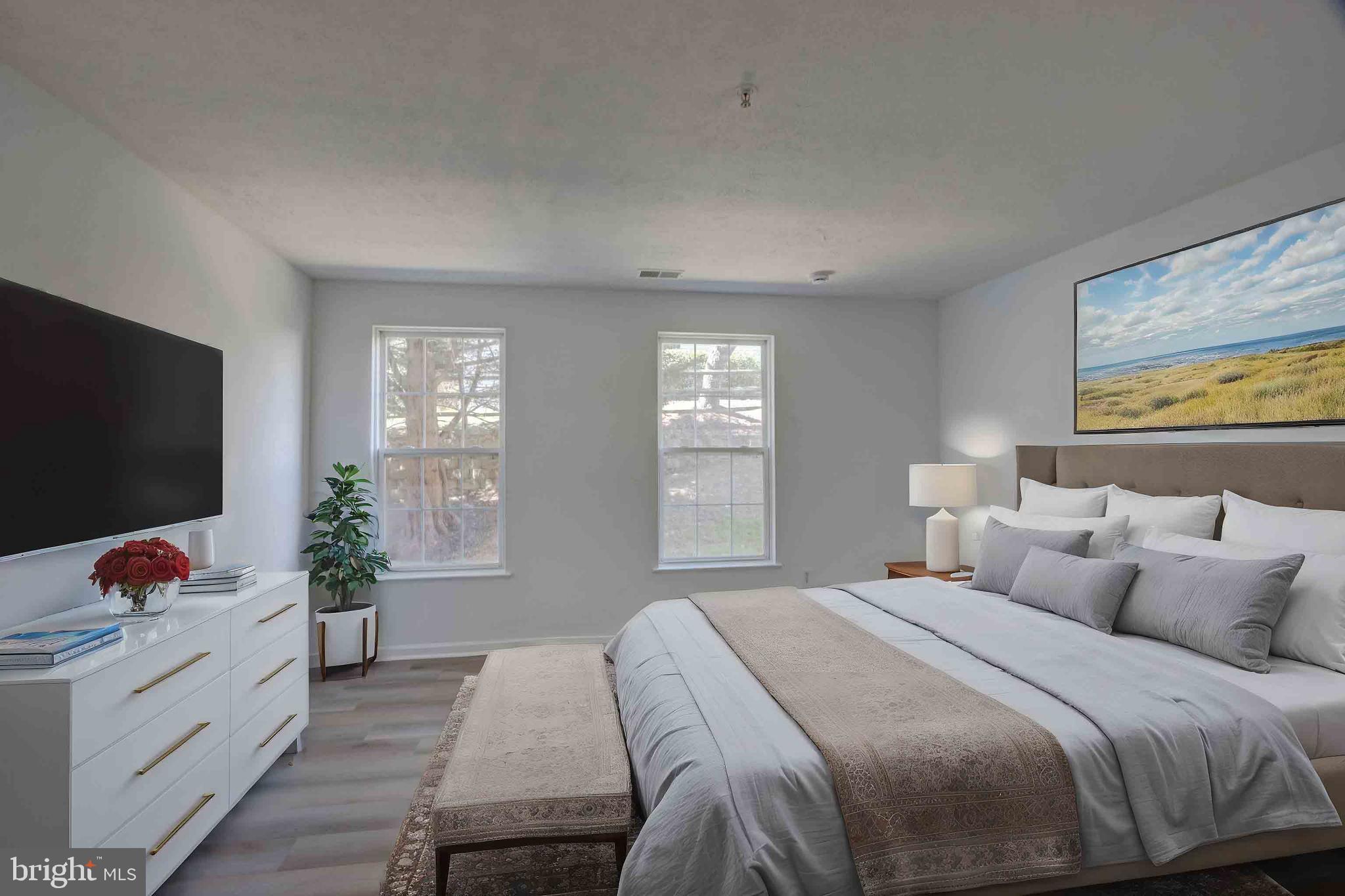 7903 Valley Manor Road, Unit 103 Owings Mills, MD 21117 - Photo 45 of 58 a bedroom with a bed and a flat screen television