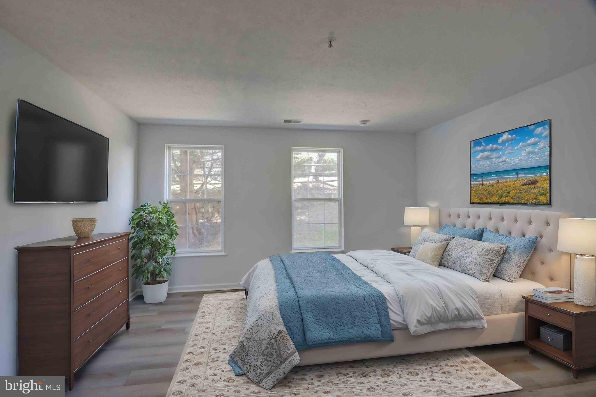 7903 Valley Manor Road, Unit 103 Owings Mills, MD 21117 - Photo 46 of 58 a bedroom with a bed and a flat screen television