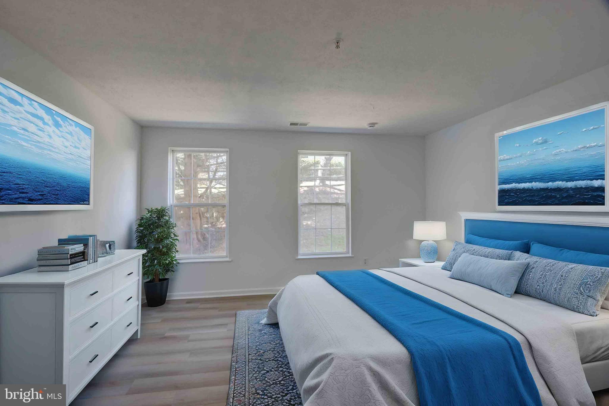 7903 Valley Manor Road, Unit 103 Owings Mills, MD 21117 - Photo 47 of 58 a bedroom with a large bed and windows