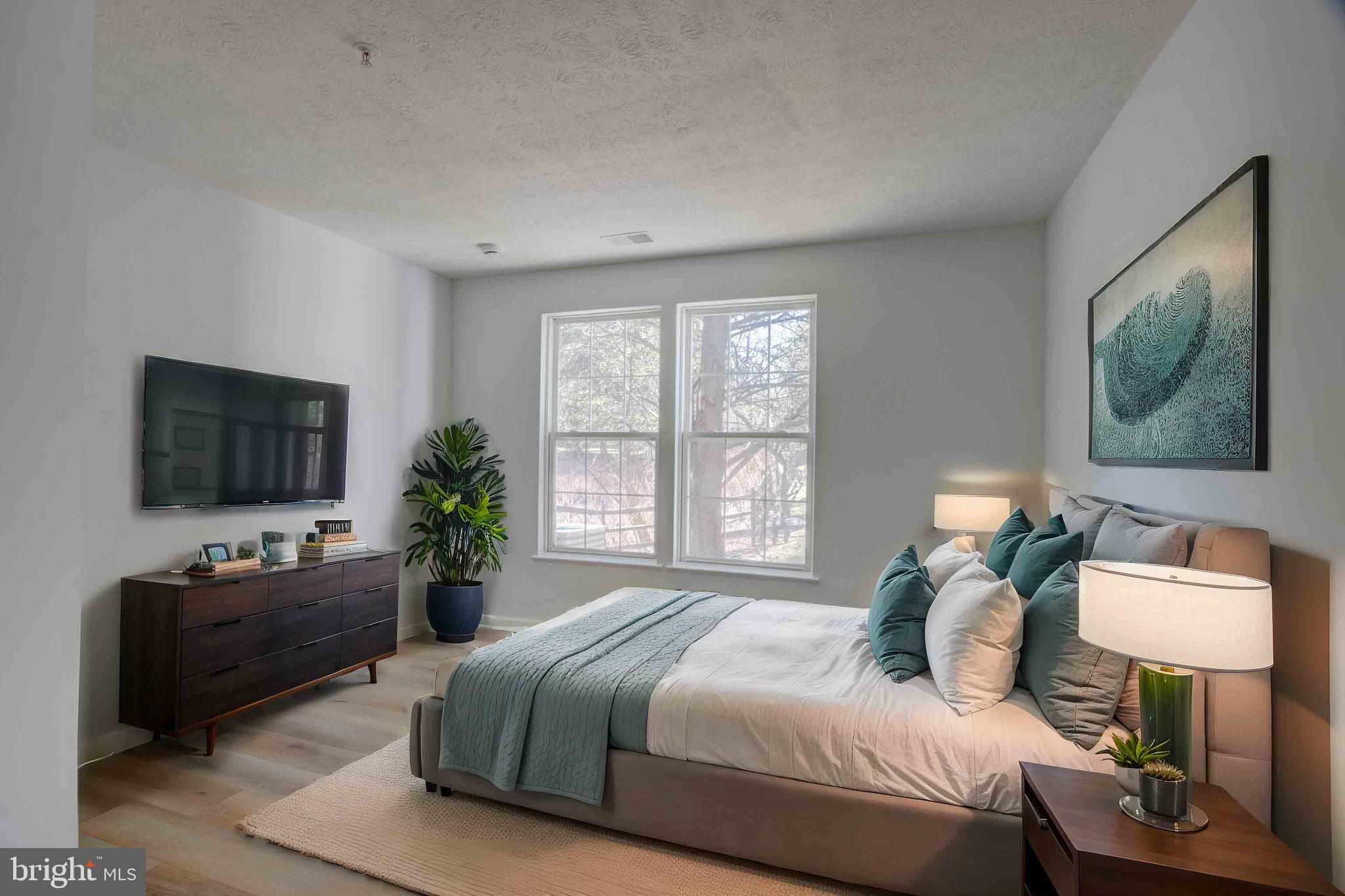 7903 Valley Manor Road, Unit 103 Owings Mills, MD 21117 - Photo 48 of 58 a bedroom with a bed and a television