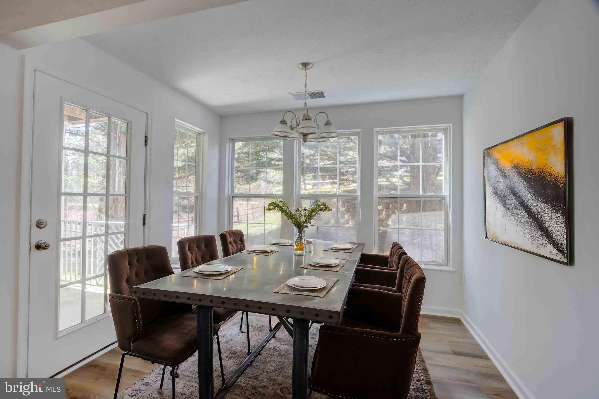 7903 Valley Manor Road, Unit 103 Owings Mills, MD 21117 - Photo 53 of 58 a view of a dining room with furniture window and wooden floor