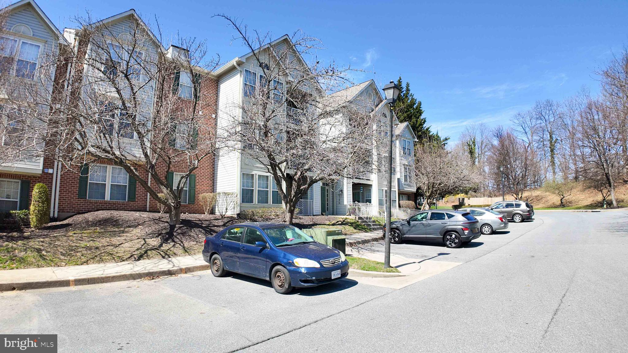 7903 Valley Manor Road, Unit 103 Owings Mills, MD 21117 - Photo 7 of 58 a car parked in front of brick house
