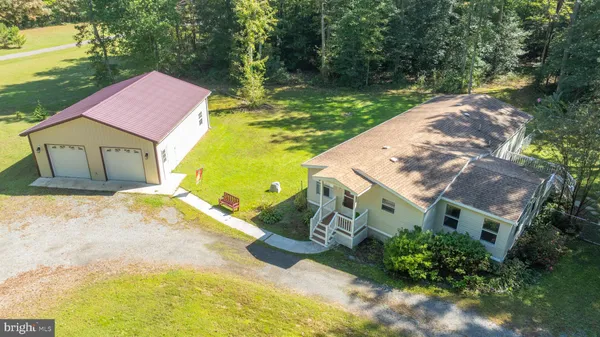 a aerial view of a house with a yard