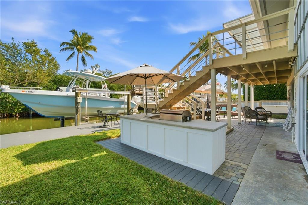 1286 Venetian Way Naples, FL 34110 - Photo 34 of 46 a view of a swimming pool with a patio