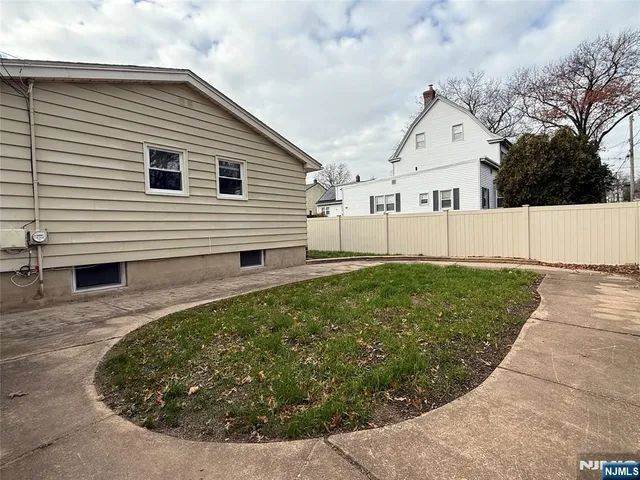 a view of house with backyard