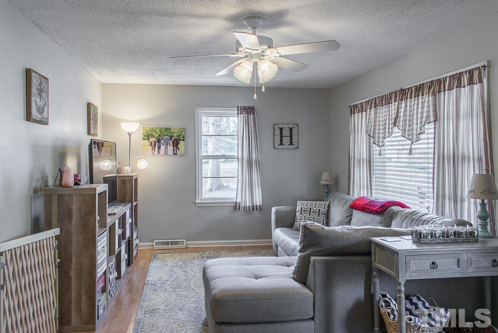 1702 Baptist Road Durham, NC 27703 - Photo 14 of 28 a living room with furniture flowerpot and a window
