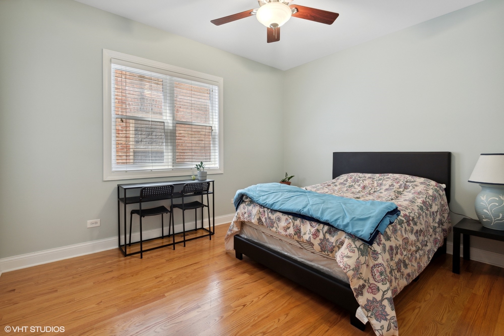 4417 South Calumet Avenue, Unit 2S Chicago, IL 60653 - Photo 12 of 16 a bedroom with a bed and a table in it