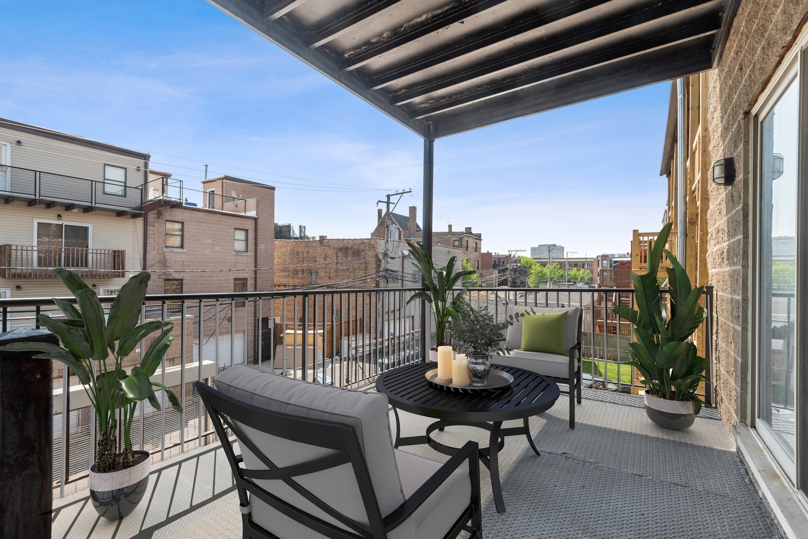 4417 South Calumet Avenue, Unit 2S Chicago, IL 60653 - Photo 15 of 16 a view of a balcony with chairs and potted plants