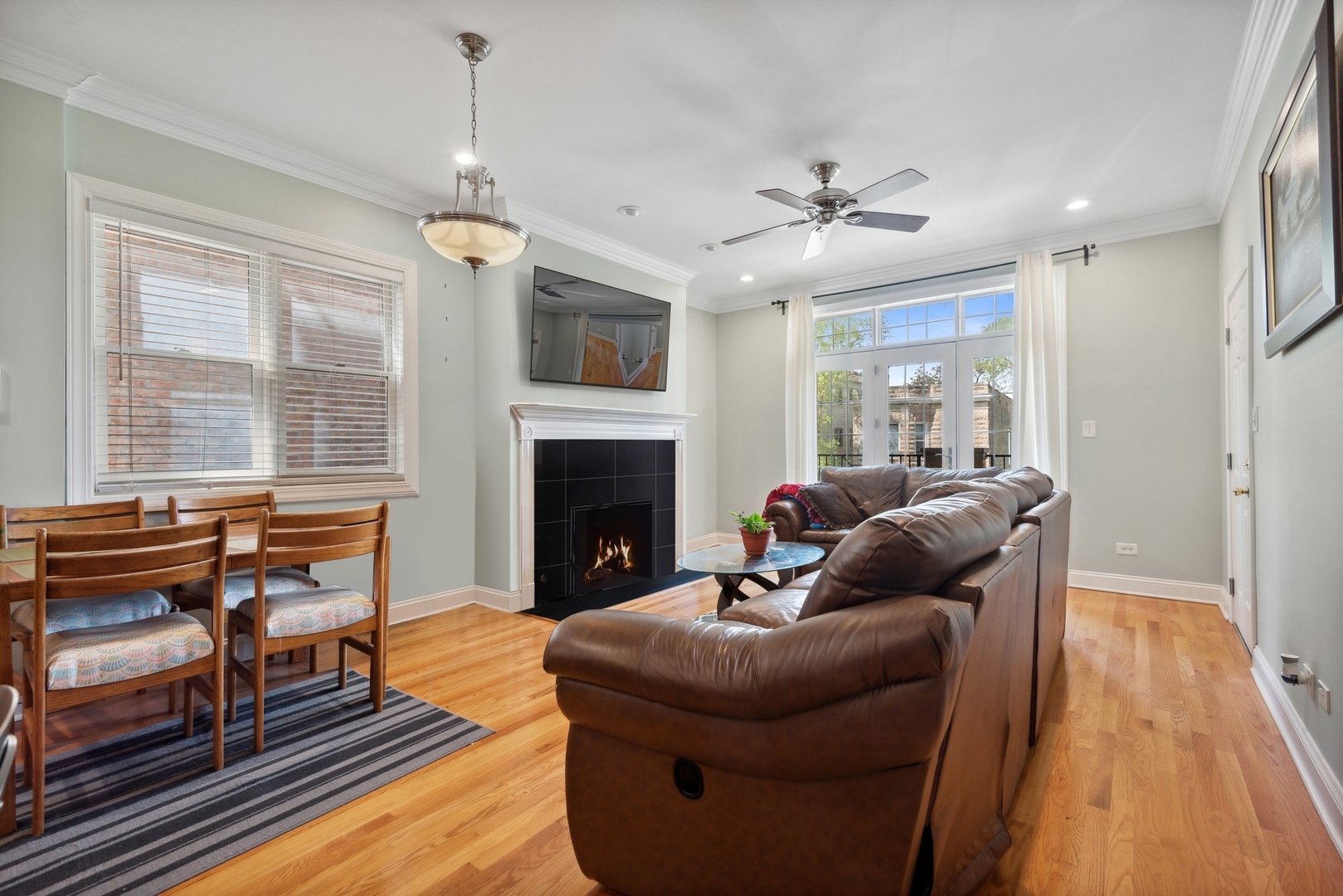4417 South Calumet Avenue, Unit 2S Chicago, IL 60653 - Photo 2 of 16 a living room with furniture a fireplace and a floor to ceiling window