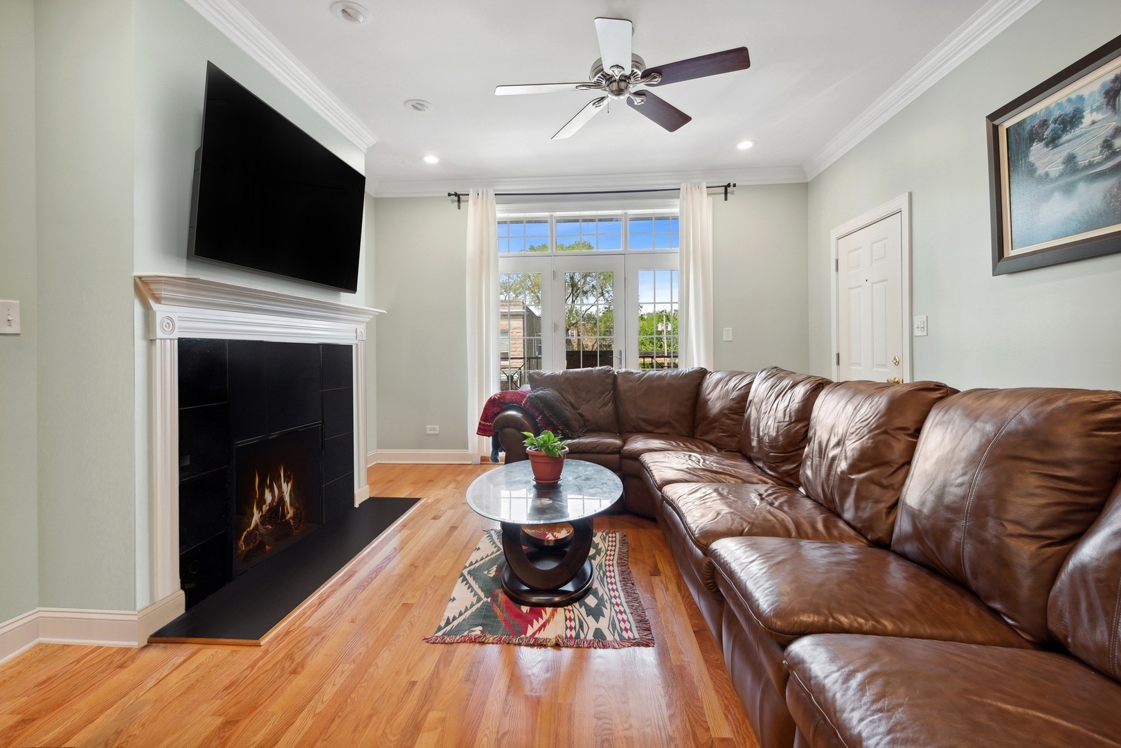 4417 South Calumet Avenue, Unit 2S Chicago, IL 60653 - Photo 3 of 16 a living room with furniture a fireplace and a flat screen tv