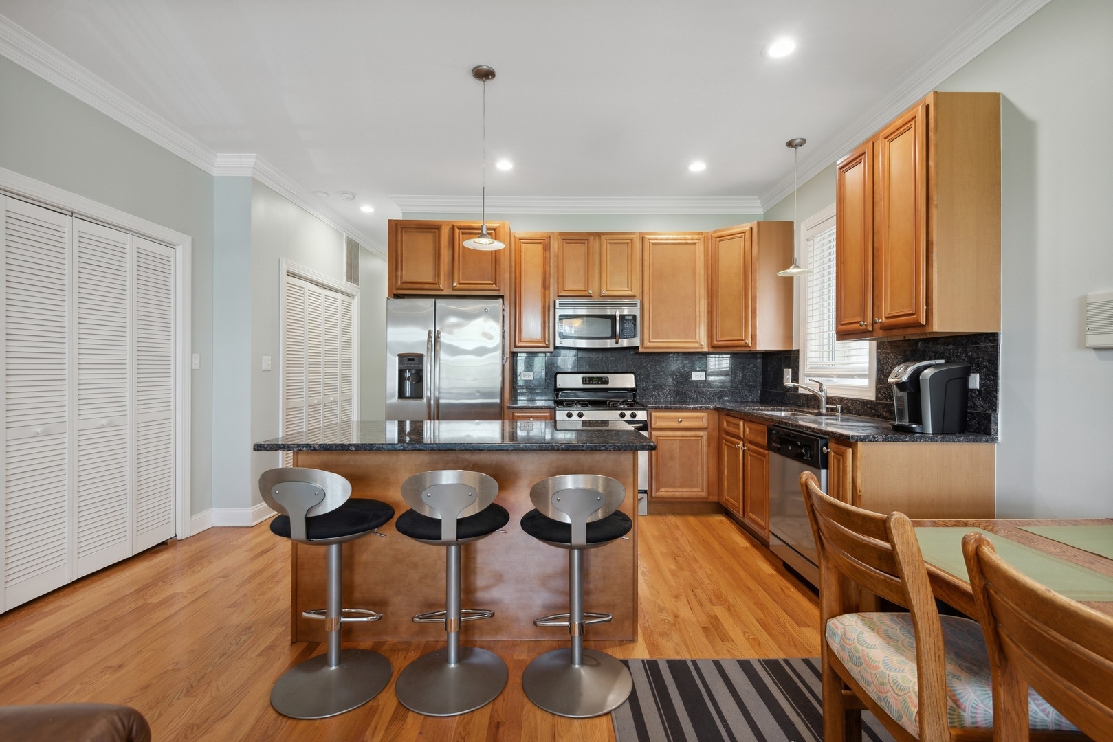 4417 South Calumet Avenue, Unit 2S Chicago, IL 60653 - Photo 5 of 16 a large kitchen with a table and chairs