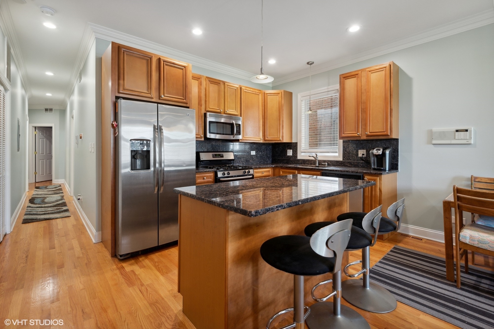 4417 South Calumet Avenue, Unit 2S Chicago, IL 60653 - Photo 6 of 16 a kitchen with stainless steel appliances granite countertop a sink a stove and a refrigerator