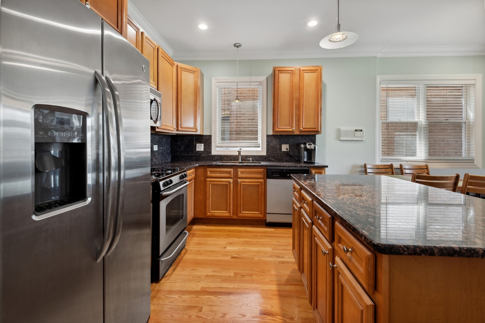 4417 South Calumet Avenue, Unit 2S Chicago, IL 60653 - Photo 7 of 16 a kitchen with stainless steel appliances granite countertop a sink a stove and refrigerator