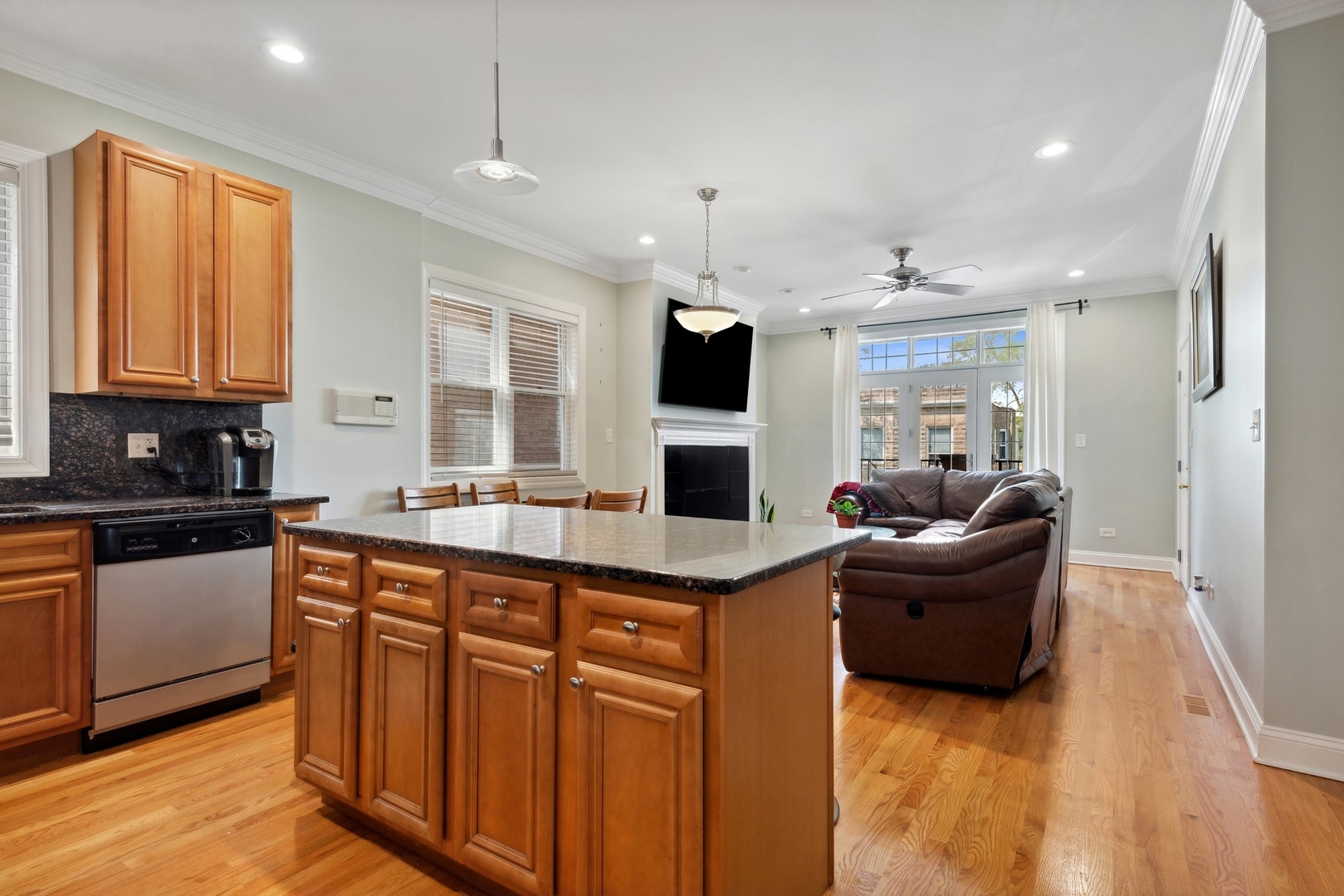 4417 South Calumet Avenue, Unit 2S Chicago, IL 60653 - Photo 8 of 16 a kitchen with kitchen island granite countertop a sink and refrigerator