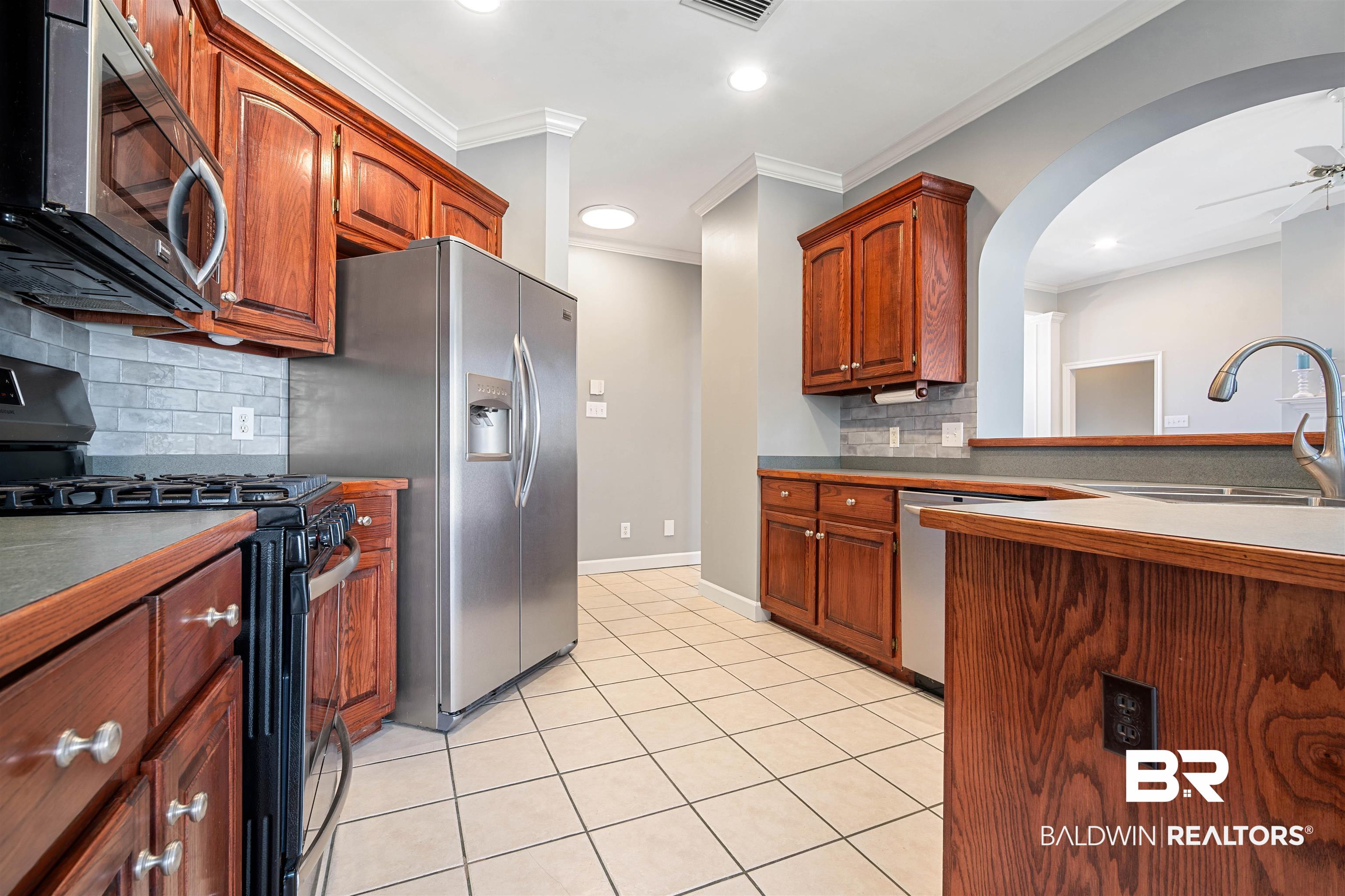 615 Summerlake Place Mobile, AL 36608 - Photo 8 of 35 Kitchen featuring appliances with stainless steel finishes, tasteful backsplash, a ceiling fan, ornamental molding, and recessed lighting