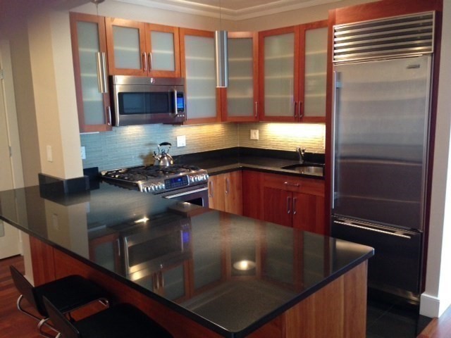 a kitchen with granite countertop a sink and a stove