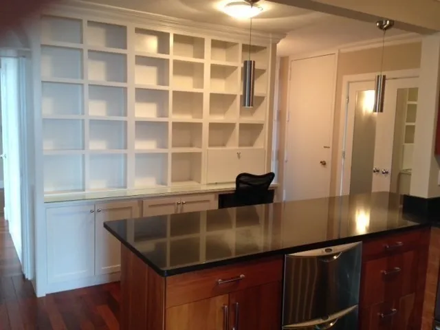a kitchen with a sink a counter space and cabinets