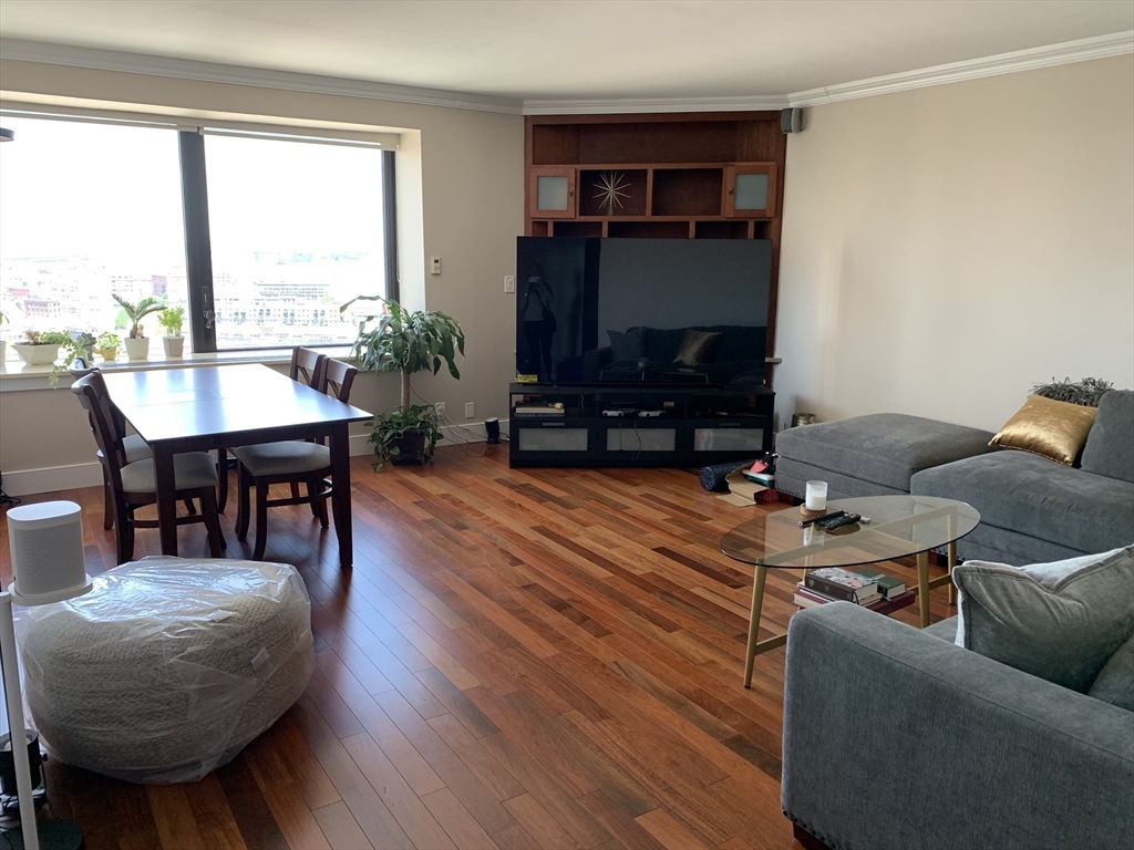 65 East India Row, Unit 22C Boston, MA 02110 - Photo 3 of 17 a living room with furniture and a flat screen tv