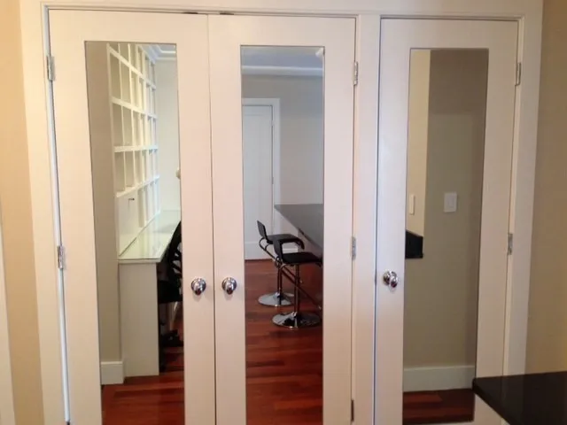a view of a hallway with wooden floor and closet