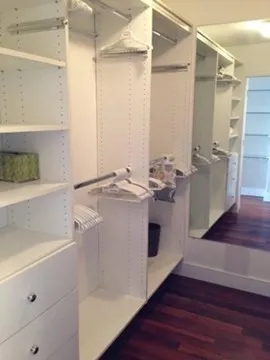 a utility room with cabinets and wooden floor