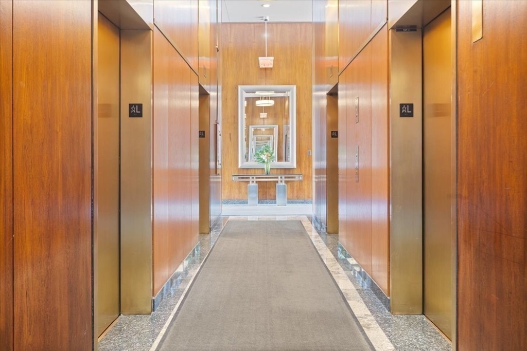 65 East India Row, Unit 22C Boston, MA 02110 - Photo 10 of 17 a view of a hallway with windows