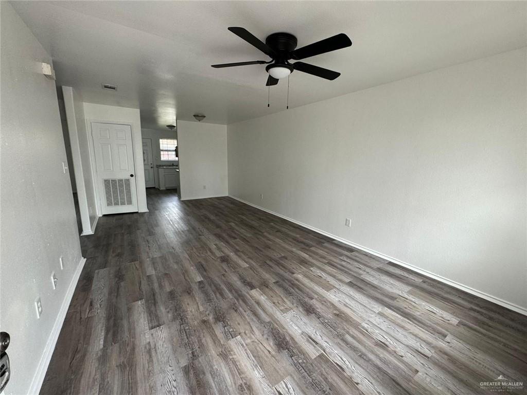 2504-2606 North M Road Edinburg, TX 78542 - Photo 3 of 9 wooden floor in an empty room with a window