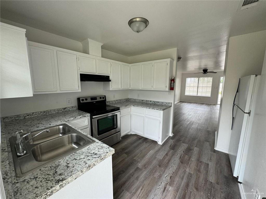 2504-2606 North M Road Edinburg, TX 78542 - Photo 4 of 9 a kitchen with a stove a sink and a refrigerator