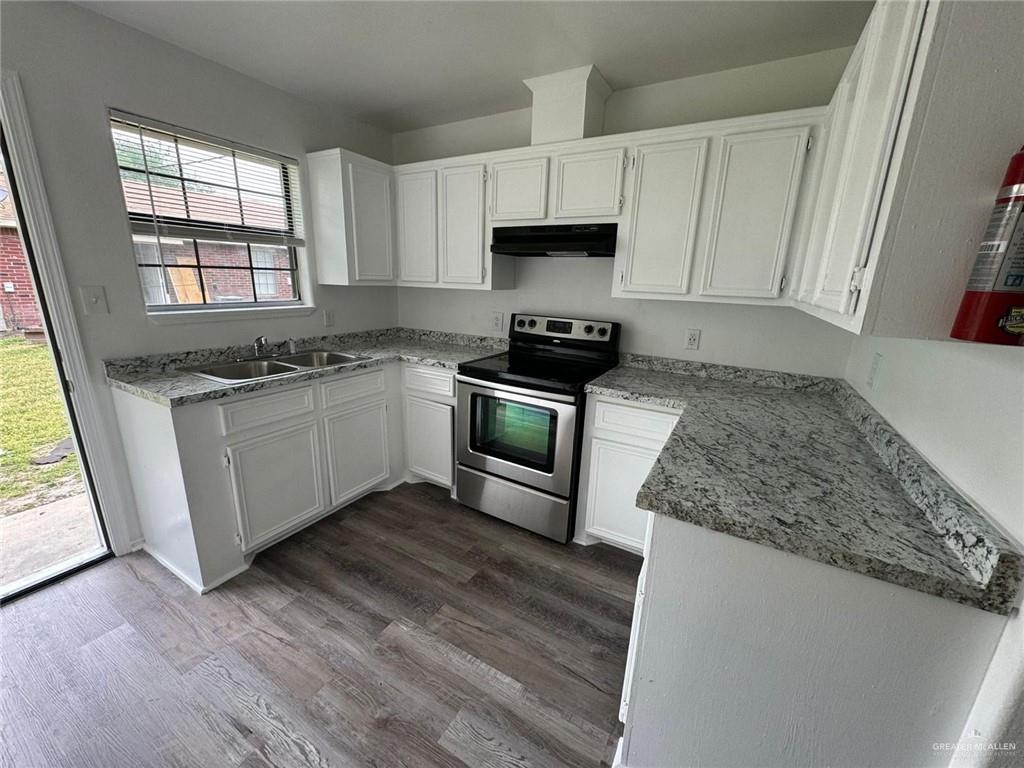 2504-2606 North M Road Edinburg, TX 78542 - Photo 5 of 9 a kitchen with stainless steel appliances granite countertop a stove a sink and a microwave
