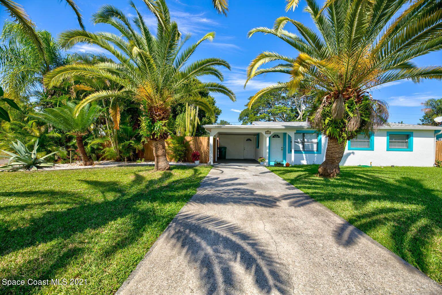 2648 Locksley Road Melbourne, FL 32935 - Photo 1 of 16 a front view of a house with garden and trees