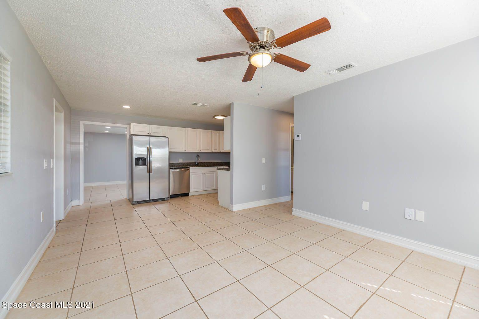 2648 Locksley Road Melbourne, FL 32935 - Photo 11 of 16 a view of a kitchen with a sink and refrigerator