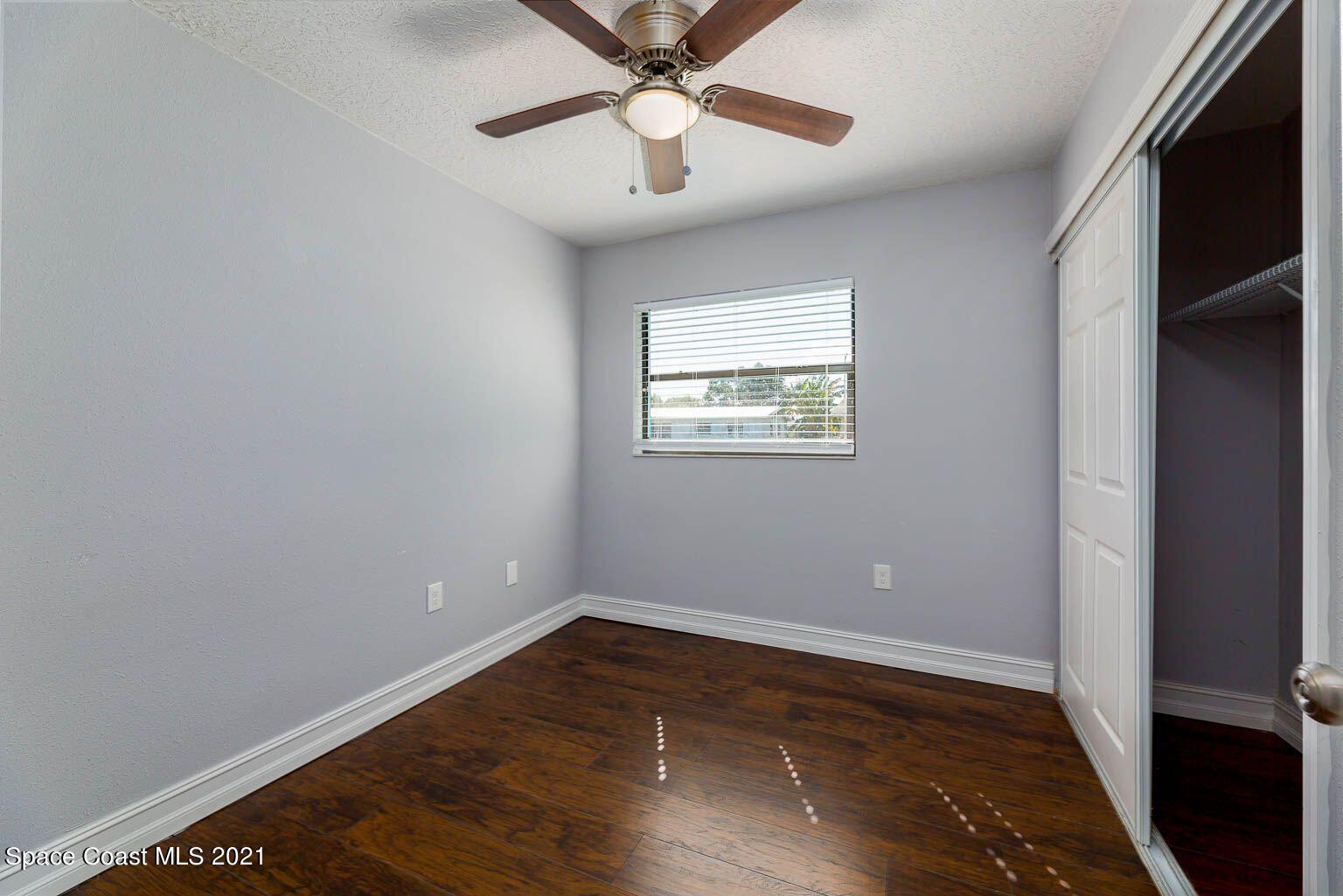 2648 Locksley Road Melbourne, FL 32935 - Photo 12 of 16 wooden floor in an empty room with a window