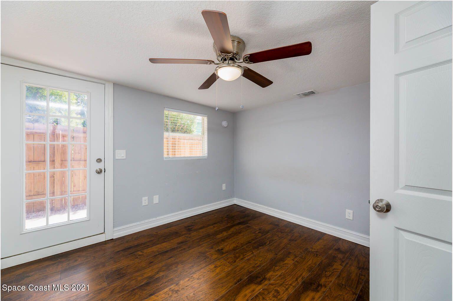 2648 Locksley Road Melbourne, FL 32935 - Photo 14 of 16 a view of empty room with wooden floor and fan