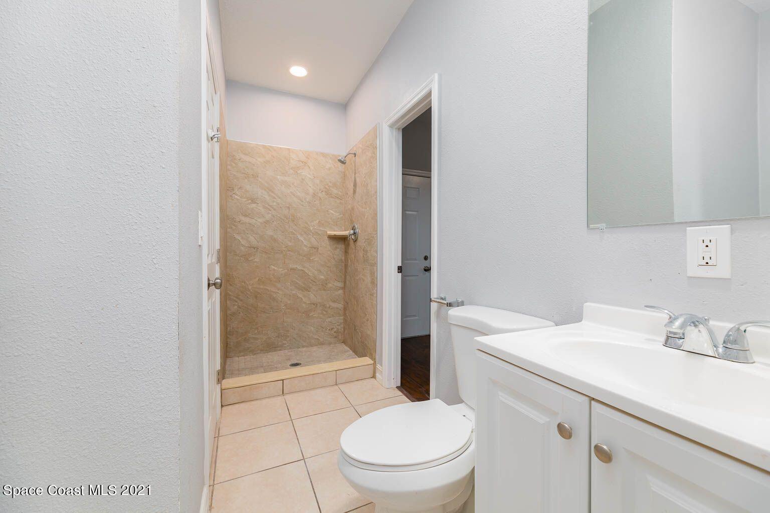 2648 Locksley Road Melbourne, FL 32935 - Photo 15 of 16 a bathroom with a sink a toilet and shower