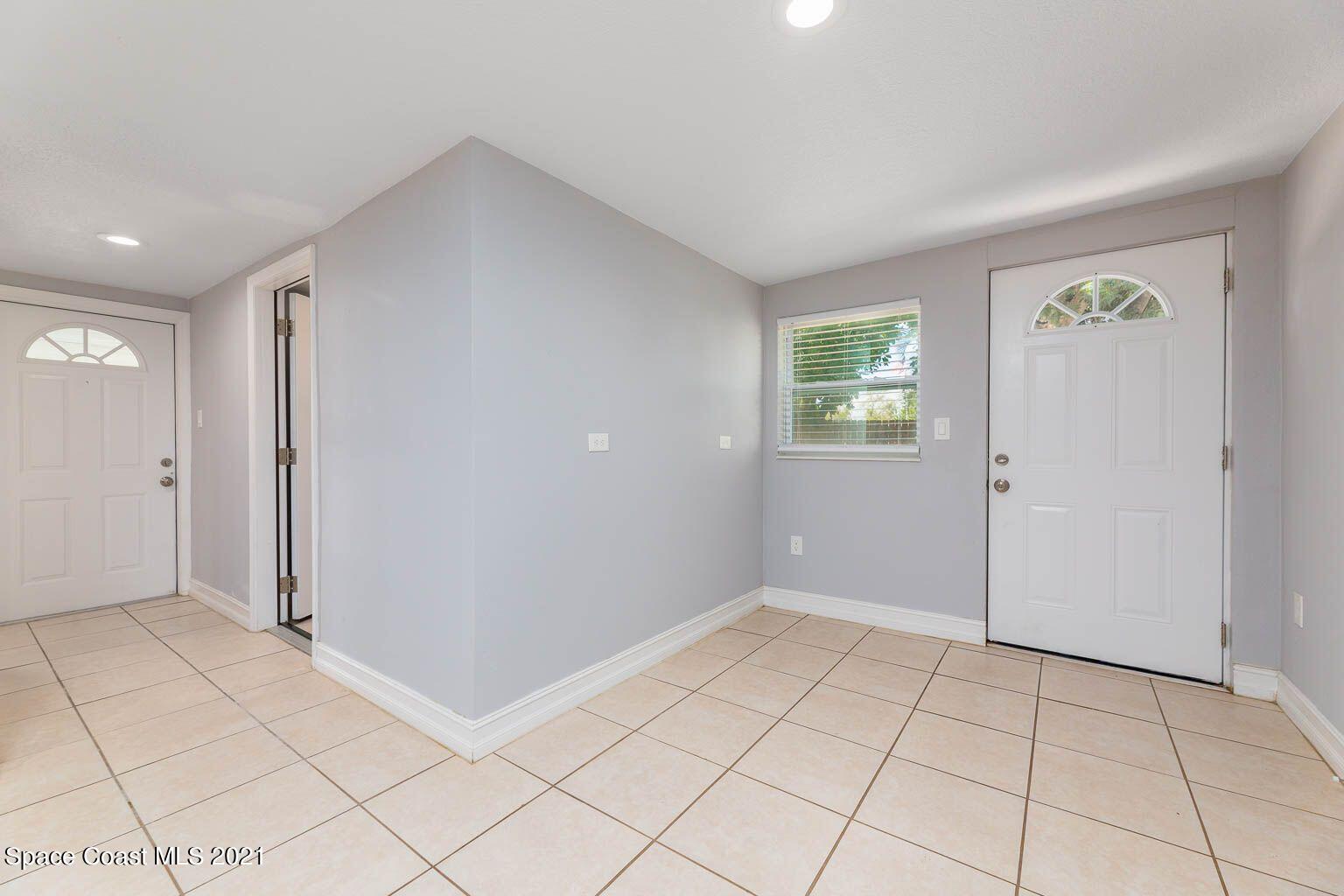 2648 Locksley Road Melbourne, FL 32935 - Photo 8 of 16 an empty room with windows