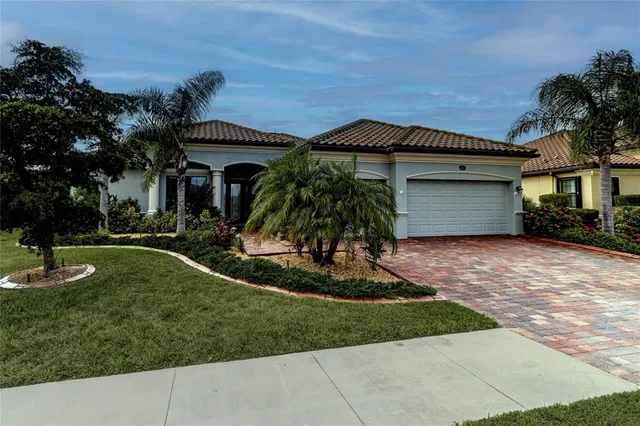 a front view of a house with a yard and garage