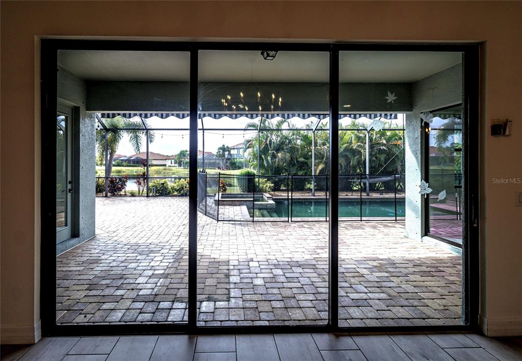 20315 Passagio Drive Venice, FL 34293 - Photo 12 of 40 a view of swimming pool and floor to ceiling window