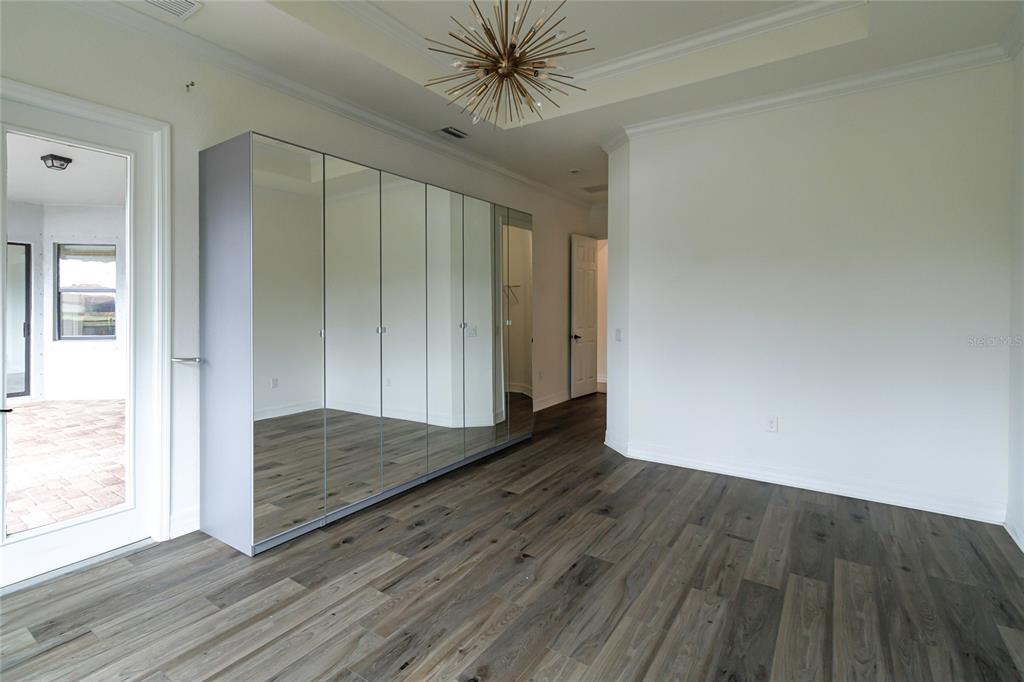 20315 Passagio Drive Venice, FL 34293 - Photo 13 of 40 a view of a hallway with wooden floor and a chandelier